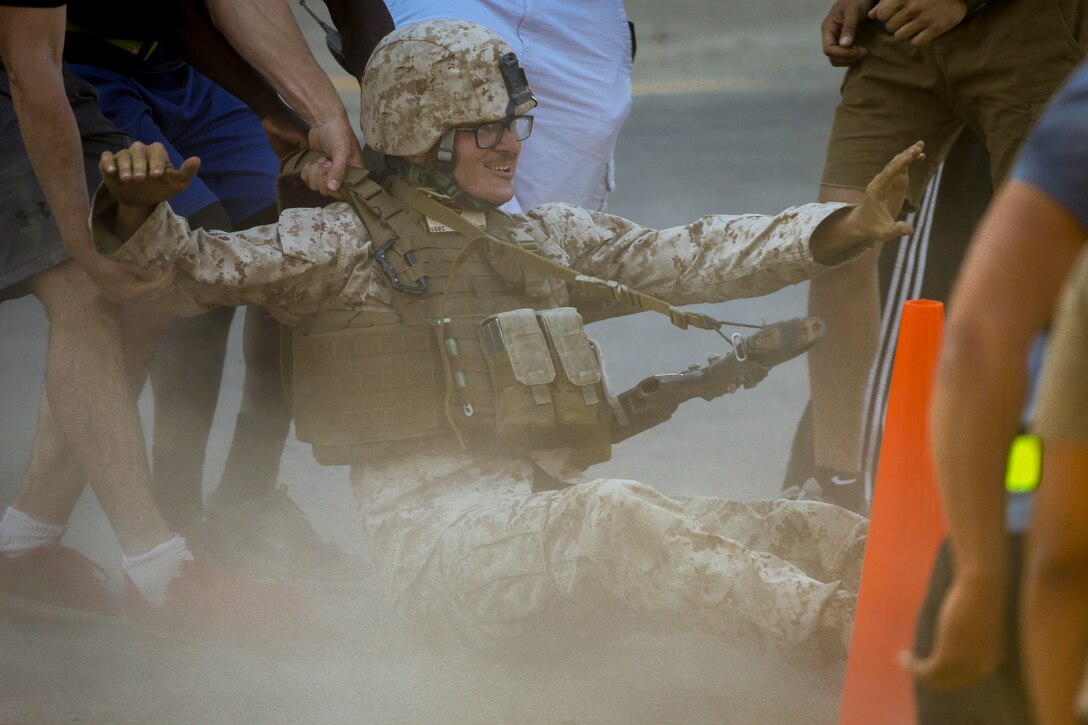 A Marine is dragged by fellow role players during an Assault Support Tactics 3 exercise as part of the Weapons and Tactics Instructor Course 2-17 at Kiwanis Park, Yuma, Ariz., April 22, 2017. The Marines is assigned to the 2nd Battalion, 6th Marine Regiment. Marine Corps photo by Staff Sgt. Artur Shvartsberg