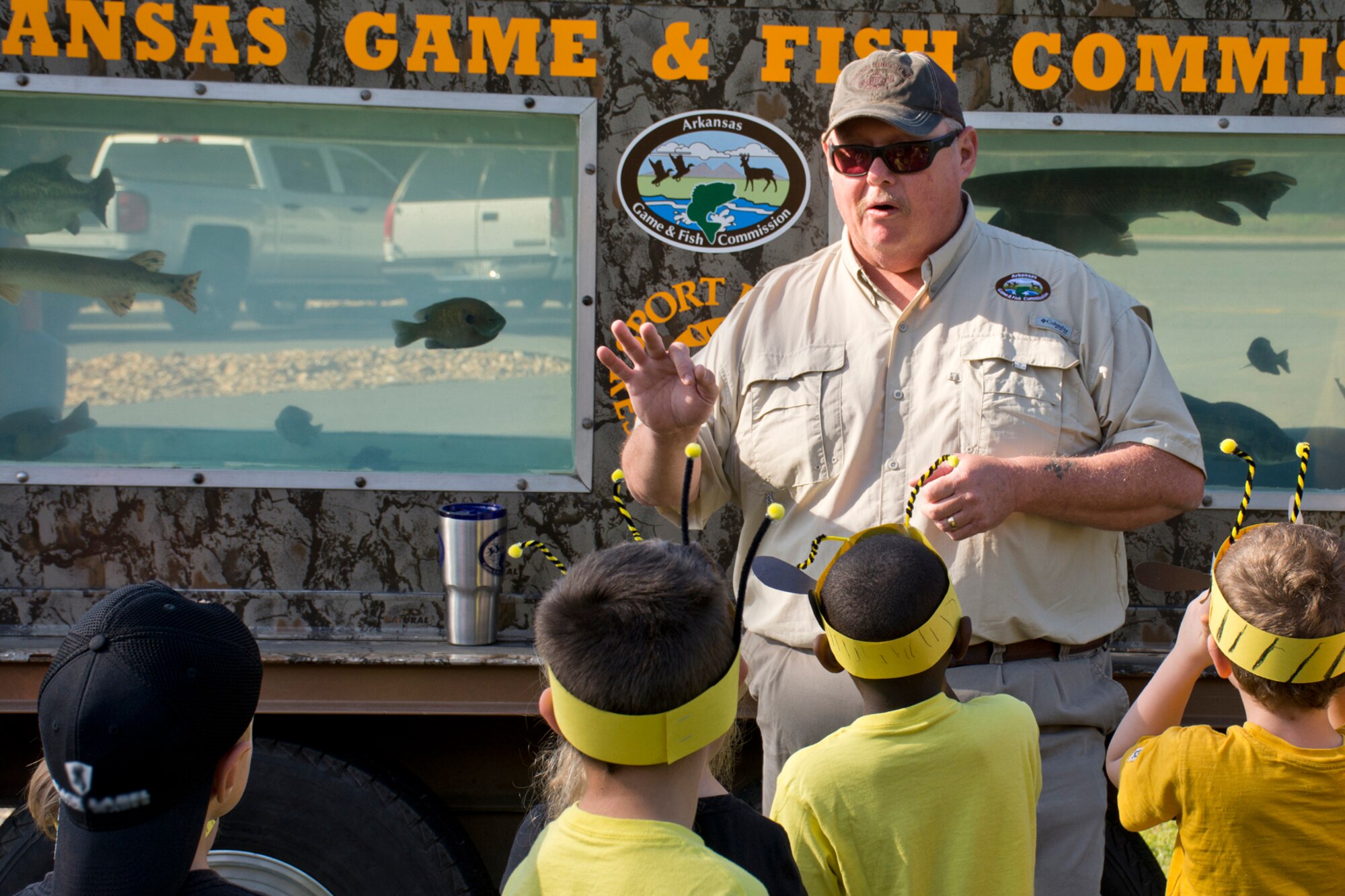 James Davidson, a national resources program technician for the Arkansas Game and Fish Commission, speaks with students about water conservation at a mobile aquarium during the Earth Day Expo held at Arnold Drive Elementary School April 20, 2017, at Little Rock Air Force Base, Ark. The Arkansas Game and Fish Commission has four mobile aquariums, which are part of their Aquatic Education Program utilized at schools, community events, fairs, festivals, outdoor shows and youth events featuring native fish and turtles. (U.S. Air Force photo by Master Sgt. Jeff Walston/Released)