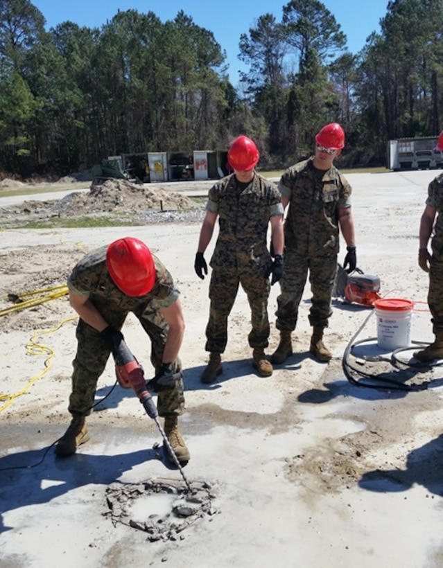 On March 20, 2017, Marines attached to Combat Engineer Officer course 3-17 (CEO 3-17) use a hammer drill to conduct spall repairs.  During their period of instruction, CEO students learn to conduct spall repairs, crater repairs, and lay AM2 matting in order to plan for airfield damage repair projects.  Pictured from left to right:  Second Lieutenants Joshua Raphaelson, Alexander Irwin, and Dylan Chung.
