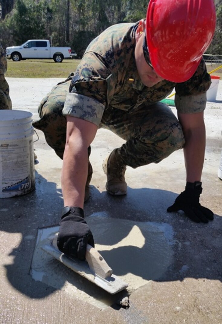 On March 20, 2017, Marines attached to Combat Engineer Officer course 3-17 (CEO 3-17) use Pavemend and float to conduct spall repairs. During their period of instruction, CEO students learn to conduct spall repairs, crater repairs, and lay AM2 matting in order to plan for airfield damage repair.  Pictured in this photo is Second Lieutenant Reynaldo Gutierrez.

