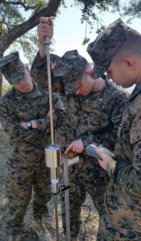 On March 9, 2017, Marines attached to Combat Engineer Officer course 3-17 (CEO 2-17) use the Dual Mass, Dynamic Cone Pentrometer to test the bearing capacity of the soil. During their period of instruction, CEO students learn soil properties and characteristics, how to test soil composition, and what to stabilize a given soil with; in order to plan for horizontal construction projects. Pictured from left to right:  Second Lieutenants Jacob Ridings, Alexander Irwin, and Dylan Chung.
