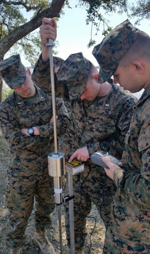 On March 9, 2017, Marines attached to Combat Engineer Officer course 3-17 (CEO 3-17) use the Dual Mass, Dynamic Cone Pentrometer to test the bearing capacity of the soil. During their period of instruction, CEO students learn soil properties and characteristics, how to test soil composition, and what to stabilize a given soil with; in order to plan for horizontal construction projects. Pictured from left to right:  Second Lieutenants Jacob Ridings, Alexander Irwin, and Dylan Chung.
