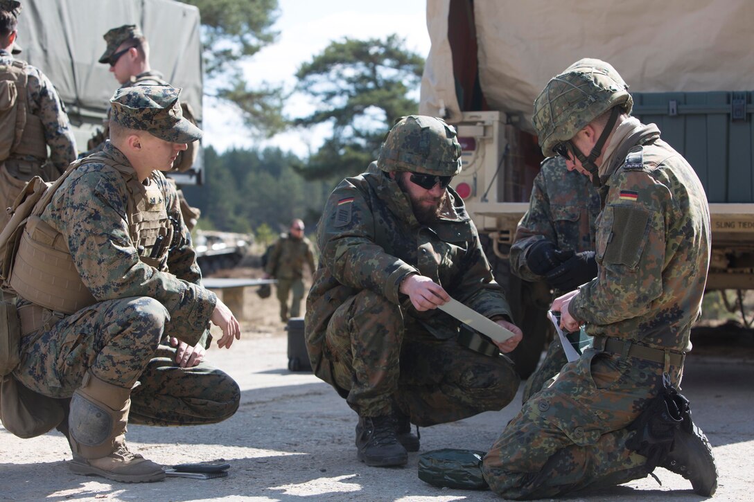 Marines and German soldiers build a charge during breach training at Exercise Summer Shield on Adazi Military Base, Latvia, April 20, 2017. Exercise Summer Shield is a multinational NATO exercise. Marine Corps photo by Sgt. Patricia A. Morris