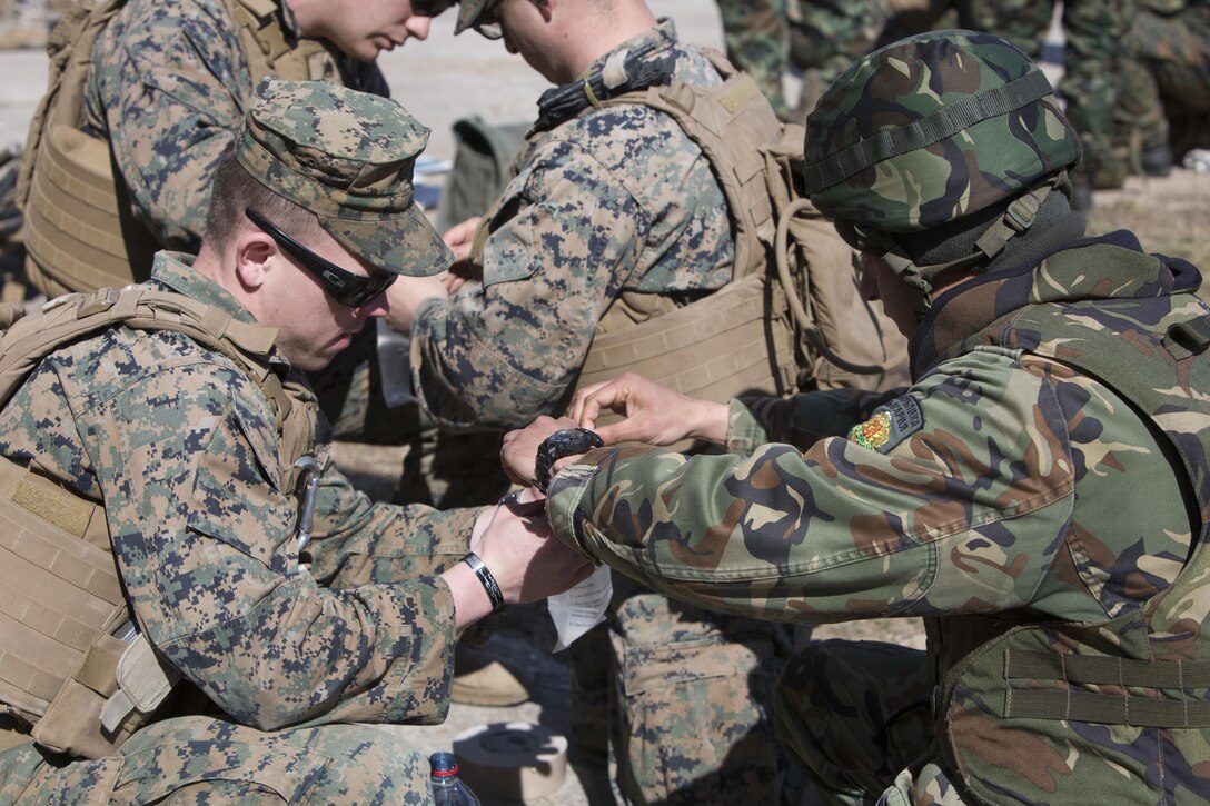 Marines and a Bulgarian soldier build water charges during breach training at Exercise Summer Shield on Adazi Military Base, Latvia, April 20, 2017. Exercise Summer Shield is a multinational NATO exercise. Marine Corps photo by Sgt. Patricia A. Morris