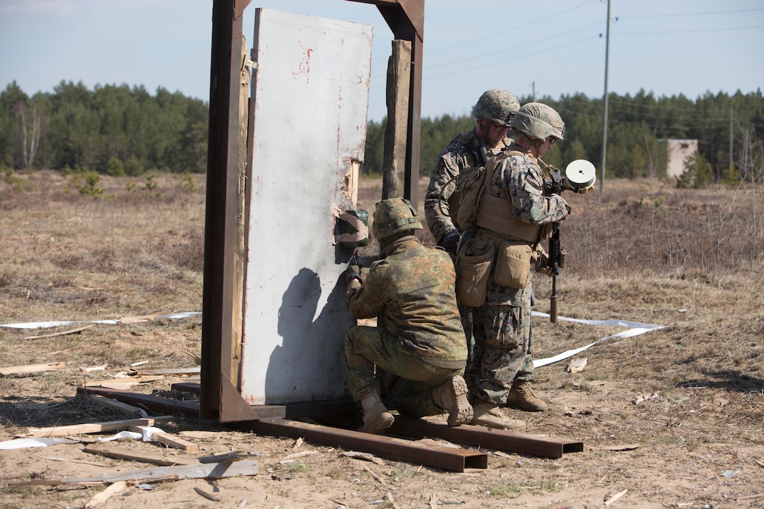 Marines and a German soldier place a water charge during breach training at Exercise Summer Shield on Adazi Military Base, Latvia, April 20, 2017. Exercise Summer Shield is a multinational NATO exercise. The Marines are assigned to the Black Sea Rotational Force 17.1. Marine Corps photo by Sgt. Patricia A. Morris