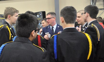 Staff Sgt. William Jones, 92nd Cyberspace Operations Center Mission Readiness NCO in Charge, speaks with local high school students about the 24th Air Force and its mission during the Mayor's Cyber Cup March 25, 2017, in San Antonio, Texas. During the 2016-2017 school year Jones led a team of Airmen mentoring students in the CyberPatriot program, which he describes as "the most effective volunteering I've ever done." 