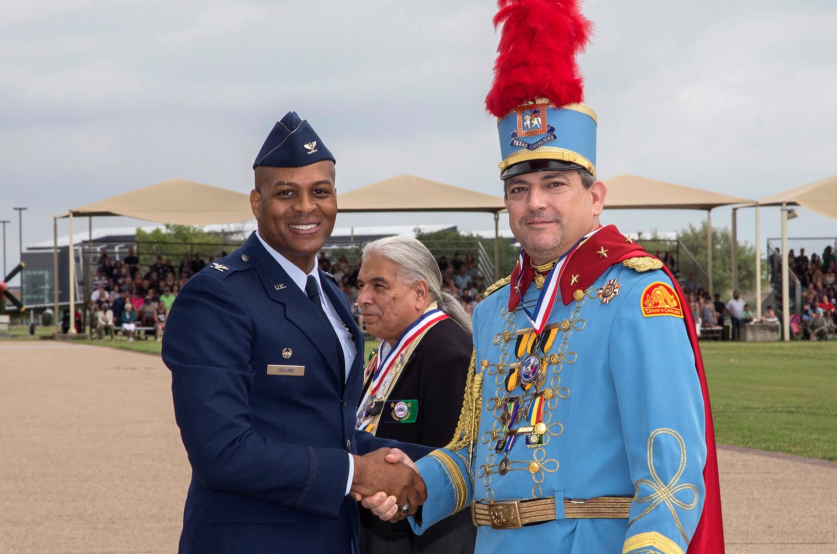 Col. Roy Collins, 37th Training Wing commander, presents a gift to 2017 Fiesta Royalty, Richard Casillas Texas Cavaliers King Antonio the 93rd, April 21, 2017, at Joint Base San Antonio-Lackland, Texas. The full-scale Basic Military Training Graduation Parade is the only military graduation incorporated into Fiesta San Antonio, the city's 10-day celebration to honor the memory of the heroes of the Alamo and the Battle of San Jacinto. Over the past century, Fiesta has grown into a celebration of San Antonio's rich and diverse cultures. Military representatives from throughout San Antonio participate in receptions, parades, pilgrimages and memorials. (U.S. Air Force photo by Johnny Saldivar)