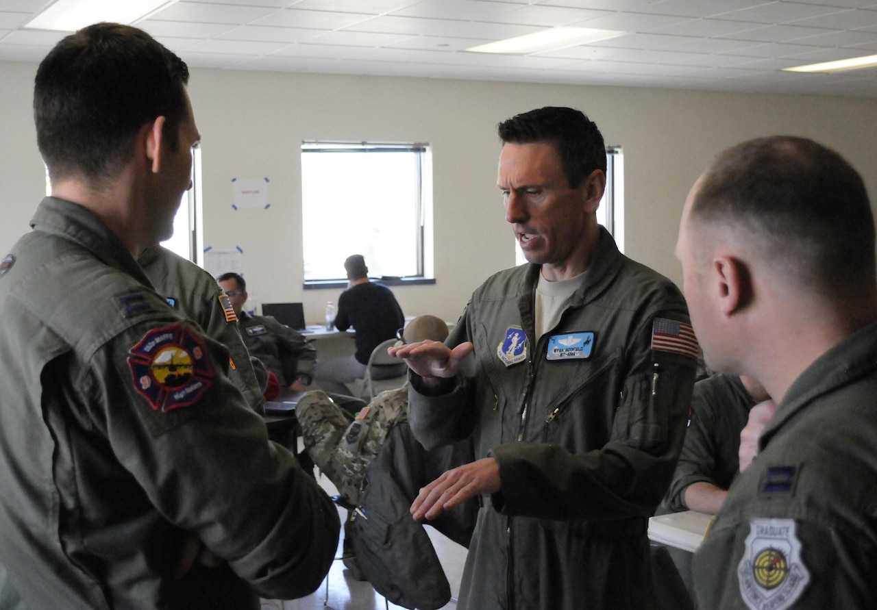 Wyoming Air National Guard Lt. Col. Ryan Scofield, a Modular Airborne Firefighting System instructor pilot, discusses an upcoming training sortie with members of Nevada Air National Guard's 152nd Airlift Wing, April 22, 2017. Members of all four Modular Airborne Firefighting System -designated wings came together for annual certification and training in Boise, Idaho, April 19-24, 2017. Wyoming Air National Guard photo by Master Sgt. Daniel Butterfield