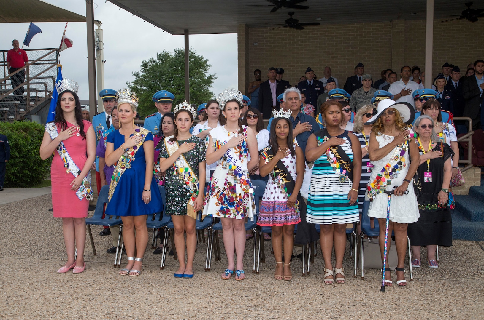 The members of the 2017 Fiesta Court stand during the playing of the Star Spangled Banner at the 2017 Air Force Basic Training Fiesta Graduation Parade April. 21, 2017, at JBSA-Lackland. The ladies attended the graduation as part of an annual tradition of Fiesta San Antonio, a 10-day celebration of military history to honor the life and memory of the members who died in the Battle of the Alamo and the Battle of San Jacinto. Beginning in 1891 as a one-day parade event, Fiesta San Antonio has evolved into a 10-day festival celebrating the heritage and history of San Antonio and the vast military community. (U.S. Air Force photo by Johnny Saldivar)