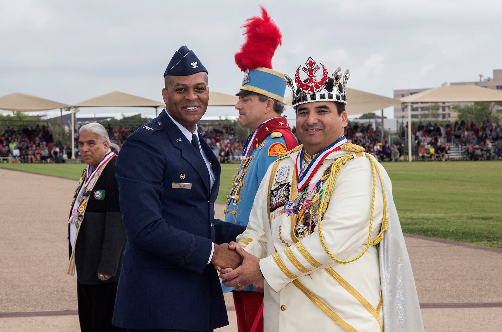 Col. Roy Collins, 37th Training Wing commander, presents a gift to 2017 Fiesta Royalty, Fernando Reyes of the Rey Feo Consejo Educational Foundation, April 21, 2017, at Joint Base San Antonio-Lackland, Texas. The full-scale Basic Military Training Graduation Parade is the only military graduation incorporated into Fiesta San Antonio, the city's 10-day celebration to honor the memory of the heroes of the Alamo and the Battle of San Jacinto. Over the past century, Fiesta has grown into a celebration of San Antonio's rich and diverse cultures. Military representatives from throughout San Antonio participate in receptions, parades, pilgrimages and memorials. (U.S. Air Force photo by Johnny Saldivar)