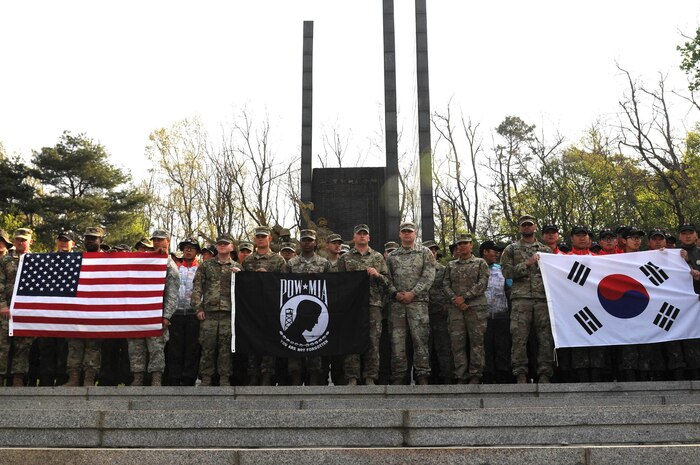 U.S. Army Soldiers with the 1st Battalion, 16th Infantry Regiment, 1st Infantry Division, Iron Rangers and the Republic of Korean Army soldiers stand together at a memorial monument during Task Force Smith KIA Remains Recovery Operation event in Osan, South Korea, April 21. During the event the ROK-U.S. Soldiers excavated the ground in search of the remains of Soldiers who sacrificed their lives during the Korean War, but whose bodies were lost in the unknown fields and were never retrieved. 