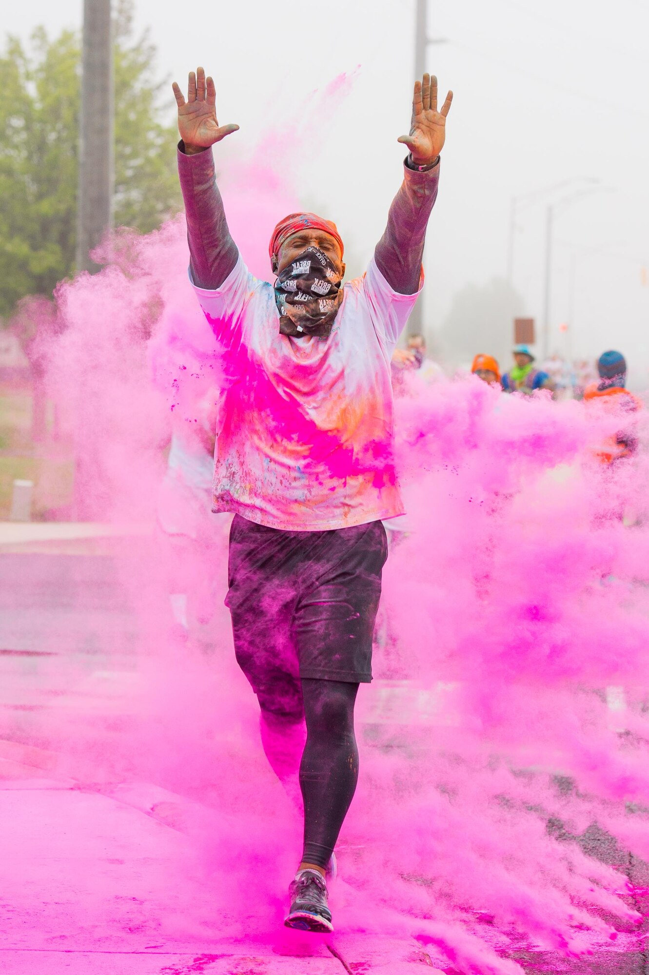 A participant of the Sexual Assault Awareness Month Color Run passes through a color station on the final stretch of the course April 21, 2017, at Dover Air Force Base, Del. Although the powder is not harmful, runners are provided scarves to prevent them from inhaling the powder during the run. (U.S. Air Force photo by Mauricio Campino)