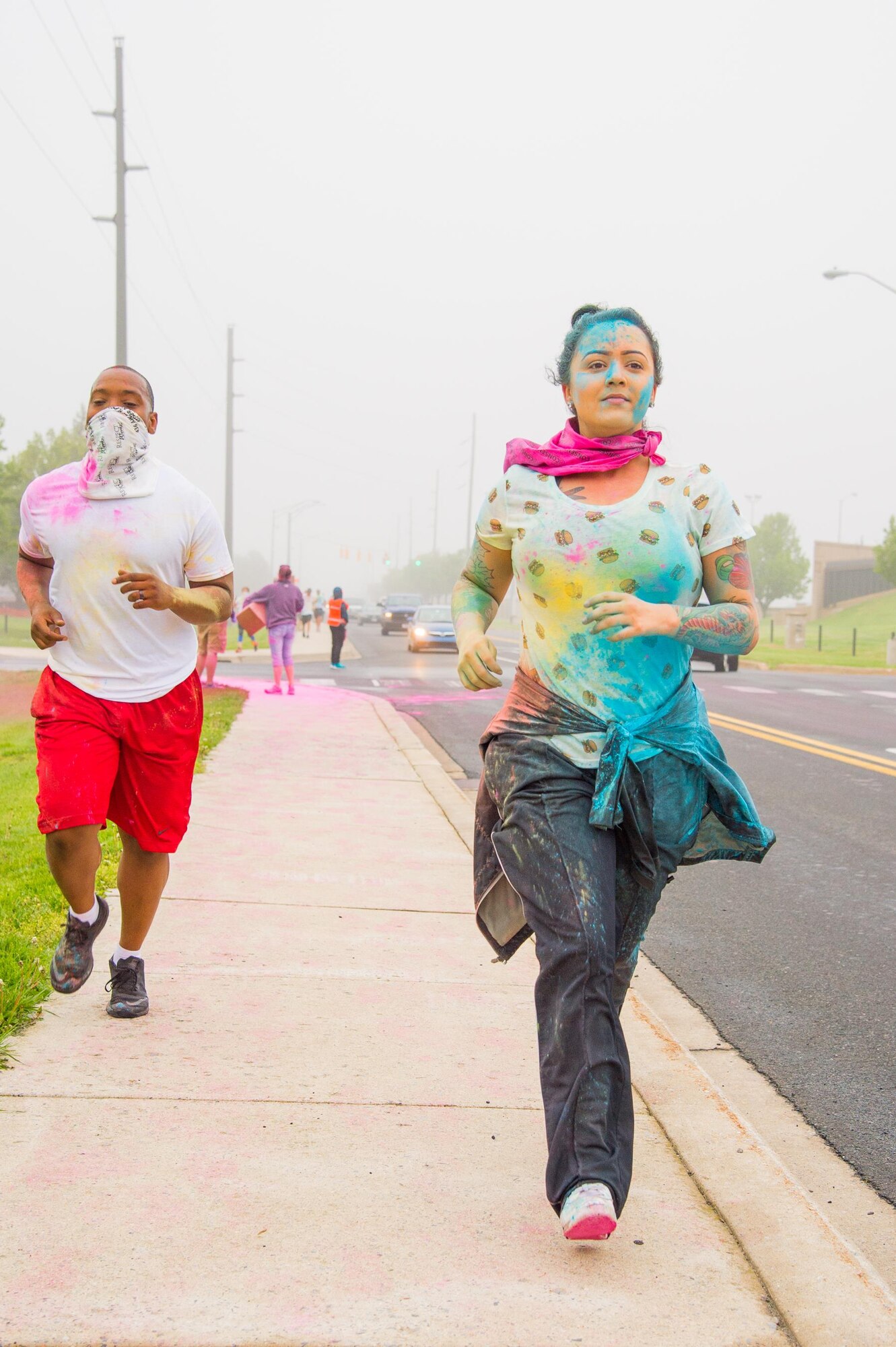 Participants of the Sexual Assault Awareness Month Color Run nearing the finish line April 21, 2017, at Dover Air Force Base, Del. The 5k course started and finished at the Joint Personal Effects Depot and ran along the full distance of Atlantic Avenue. (U.S. Air Force photo by Mauricio Campino)