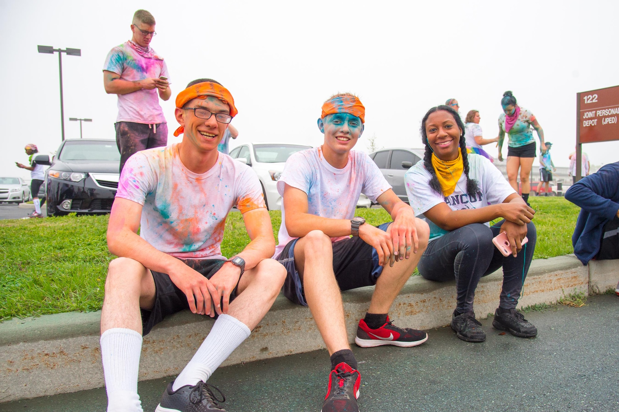 Runners rest after passing the finish line of the Sexual Assault Awareness Month Color Run April 21, 2017, at Dover Air Force Base, Del. The event was open to the entire Team Dover community. (U.S. Air Force photo by Mauricio Campino)