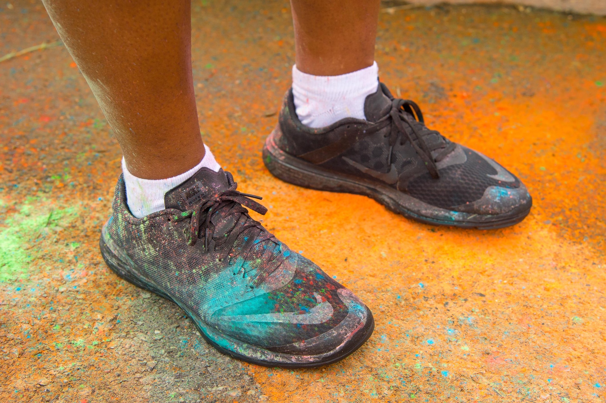 A runner displays the aftermath of the Sexual Assault Awareness Month Color Run April 21, 2017, at Dover Air Force Base, Del. The brightly colored powder is environmentally friendly and is made up of mostly cornstarch, baking soda and dyes. (U.S. Air Force photo by Mauricio Campino)