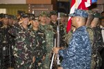 In this file photos, Armed Forces of the Philippines personnel salute as the Philippine national anthem is played during the opening ceremony for Exercise Balikatan 2016.