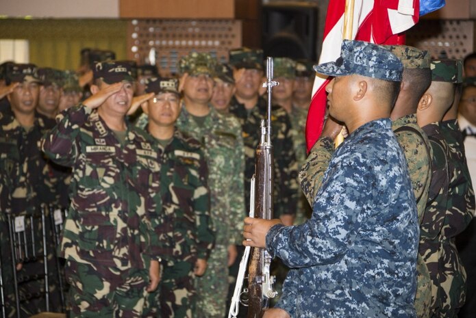 In this file photos, Armed Forces of the Philippines personnel salute as the Philippine national anthem is played during the opening ceremony for Exercise Balikatan 2016.