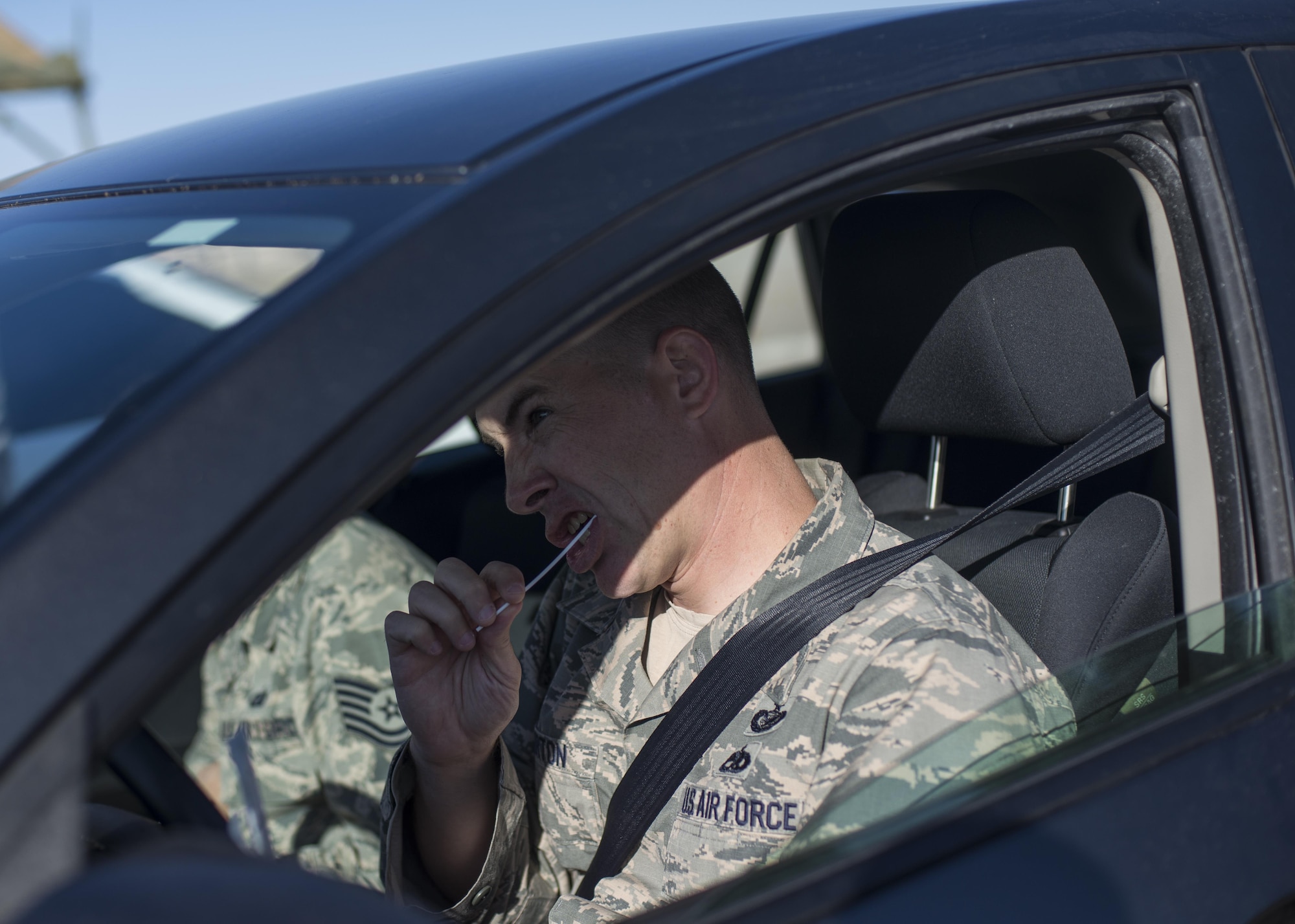 Tech. Sgt. Jeffry Howerton, Holloman Air Force Base broadcast communication non-commissioned officer in charge, swabs his inner cheek during the 49th Medical Group’s Swab-Thru event, at Holloman Air Force Base, N.M. on April 20, 2017. The Swab-Thru, coordinated with the “Salute to Life” program, is a special drive-thru bone marrow registration event. The event was held in the parking lot across from the MDG. Over 100 Airmen nestled their cars into the lot and registered with the “Salute to Life” program to show their support for victims of cancer. (U.S. Air Force photo by Airman 1st Class Alexis P. Docherty) 