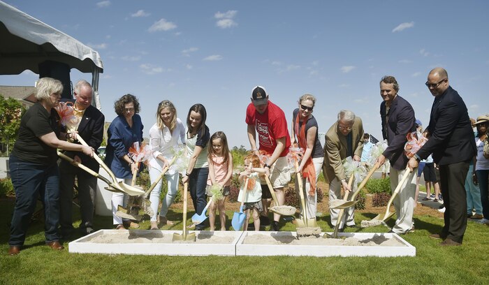 U.S. Marine Corps Lance Cpl. Jeremy Brooking and his family, center, break ground with representatives from Operation Finally Home and various organizations during a ground breaking ceremony at Carnes Crossroads community, April 22, 2017, in Summerville, S.C. Brooking was injured during a deployment to Iraq in 2007 and through the efforts of Operation Finally Home and other organizations, was given a mortgage-free house tailored to fit the family’s needs. Airmen and Sailors from Joint Base Charleston attended the event to show support to the Brooking family. 