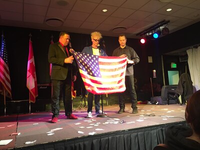(Left) Maj. Wayne Capps, 315th AW Public Affairs Officer, along with Murray Sawchuck (Center), and Dace Chandler perform magic illusions April 16, 2017, to military members in Greenland. The magicians made an American flag appear during an illusion to show appreciation to military service members and families. (Courtesy photo)