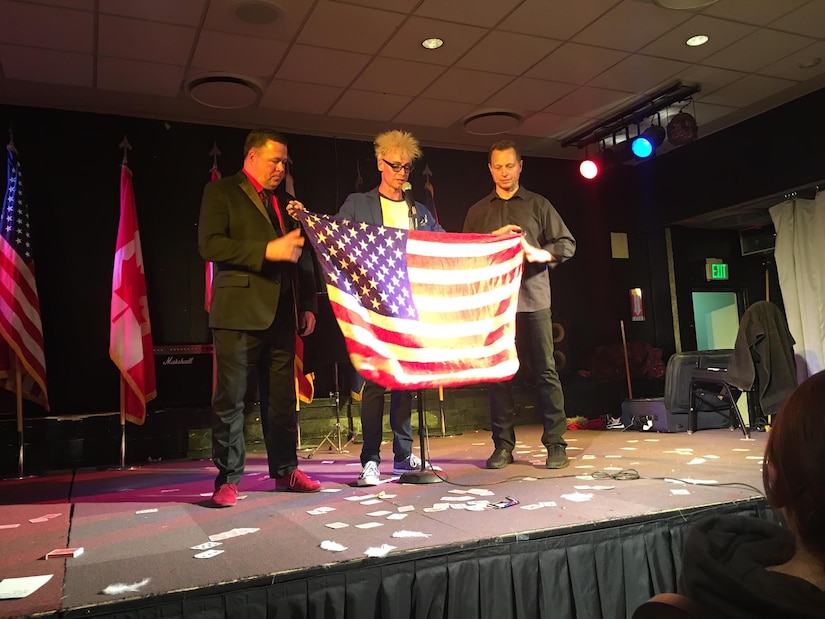 (Left) Maj. Wayne Capps, 315th AW Public Affairs Officer, along with Murray Sawchuck (Center), and Dace Chandler perform magic illusions April 16, 2017, to military members in Greenland. The magicians made an American flag appear during an illusion to show appreciation to military service members and families. (Courtesy photo)