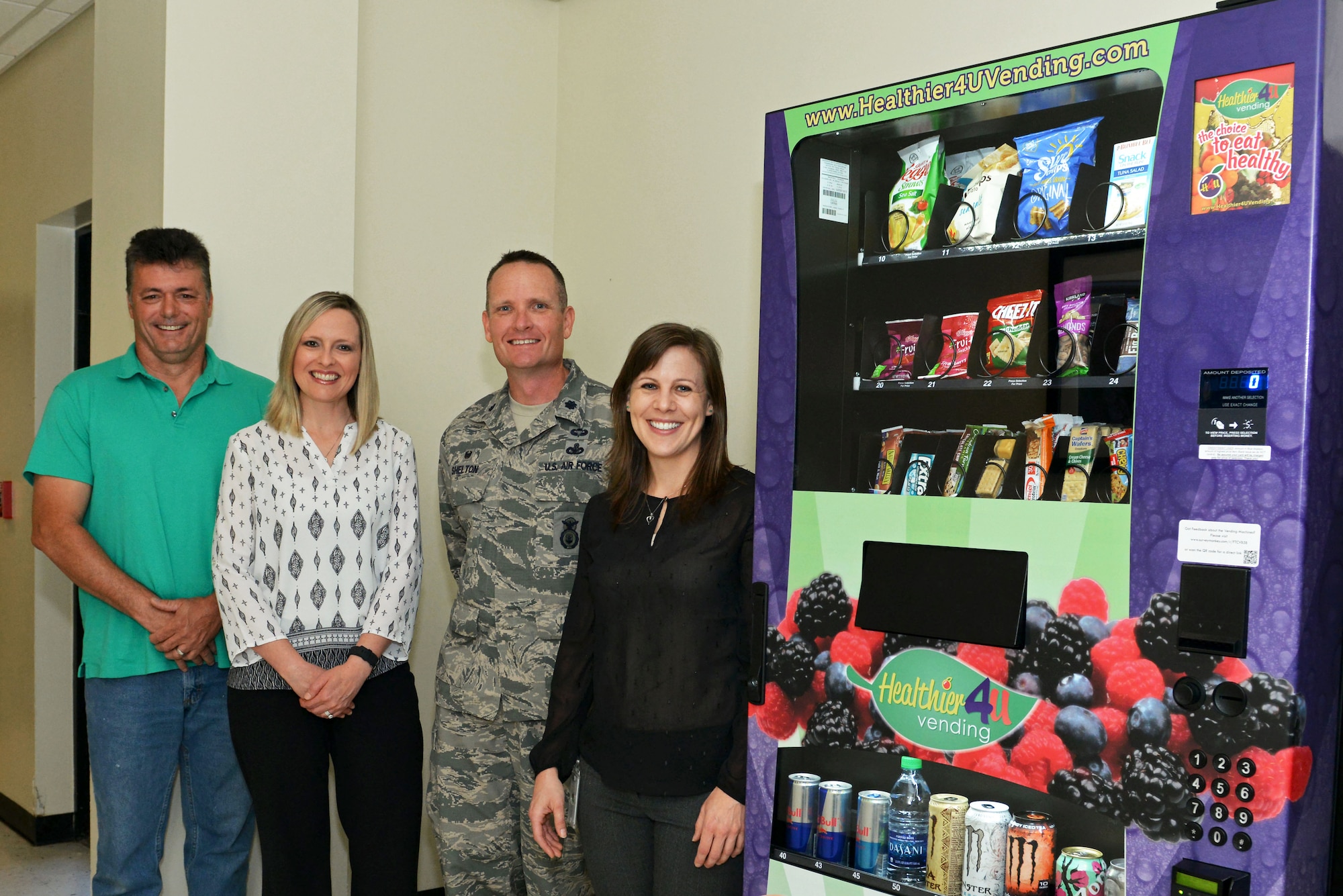 The team responsible for the vending machine with healthy food choices in the 20th Security Force’s Squadron building stands next to the vending machine at Shaw Air Force Base, S.C., April 21, 2017. The healthy vending machine offers snack options to Airmen based on Health Promotion requirements to help keep them fit to fight. (U.S. Air Force photo by Airman 1st Class Destinee Sweeney)