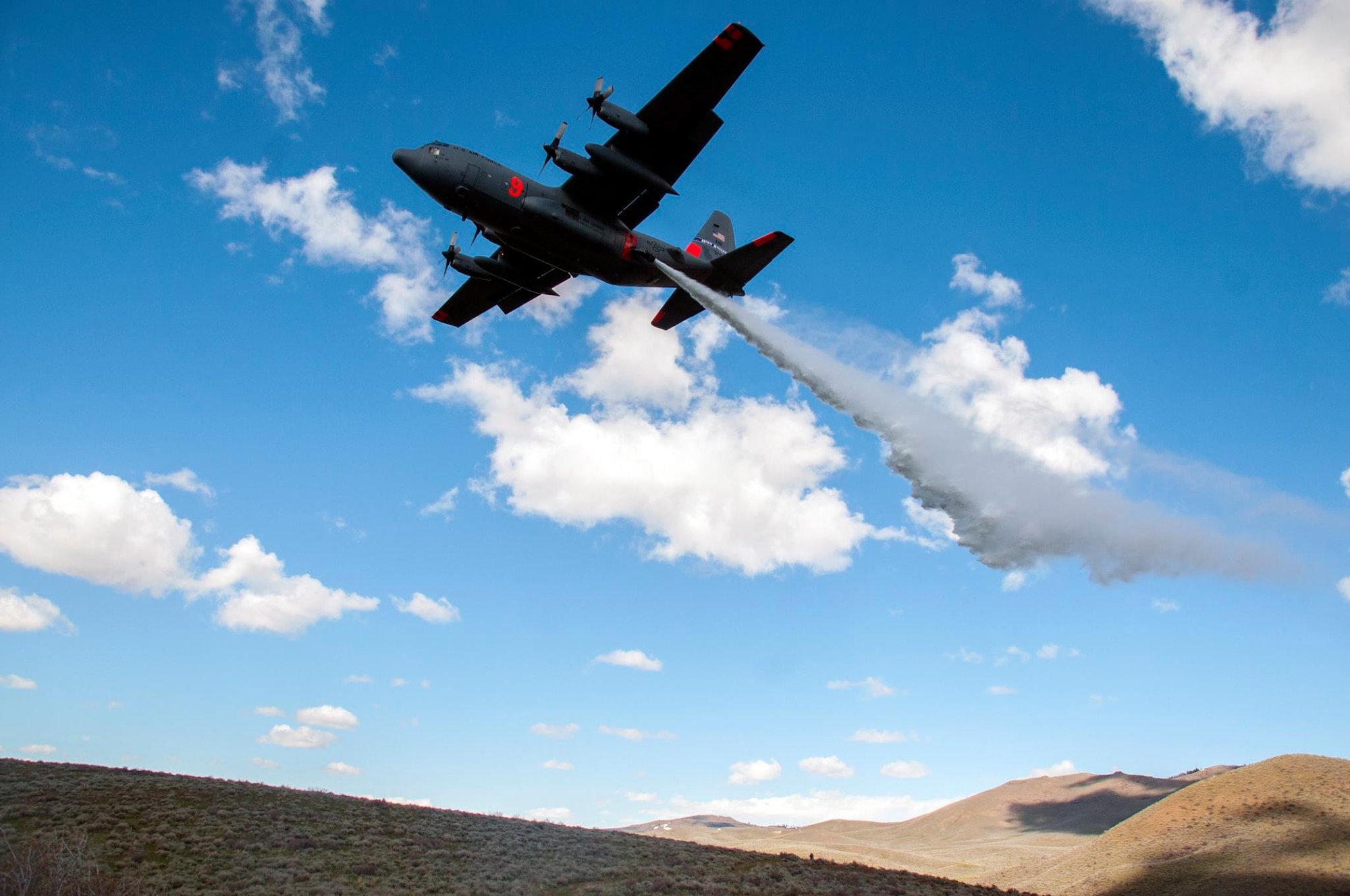 A Nevada Air National Guard, 152nd Airlift Wing C-130 does a water drop during training April 21, 2017 in the mountains outside Boise, Idaho. All four C-130 units: 302nd Airlift Wing (Air Force Reserve unit), 146th Airlift Wing, 153rd Airlift Wing and 153rd Airlift Wing (all three Air National Guard units) gathered  to do their annual Modular Airborne Fire Fighting System certification/recertification training from April 19-25, 2017.