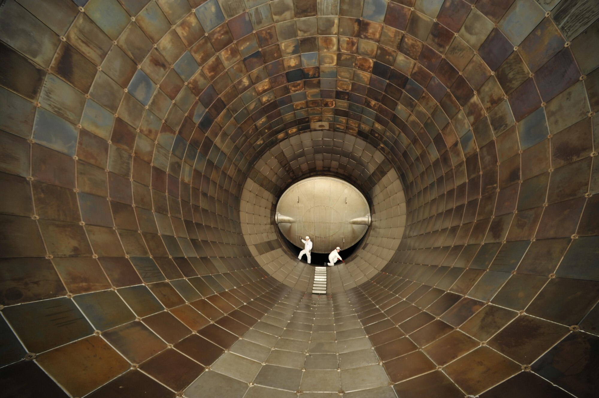 AEDC workers inspect tiles in the Propulsion Wind Tunnel 16-foot Supersonic Tunnel in 2014. (U.S. Air Force photo/Rick Goodfriend)