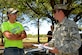 U.S. Air Force Staff Sgt. Brian Rash, 337th Recruiting Squadron recruiter, right, speaks to James Lock, a recruit, left, during a Delayed Entry Program (DEP) call at Dillon Park in Sumter, S.C., April 11, 2017. DEP members attend calls monthly and are briefed on what they can expect during Basic Military Training and as Airmen. (U.S. Air Force photo by Airman 1st Class Kathryn R.C. Reaves)