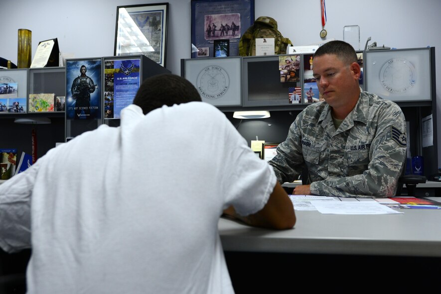 U.S. Air Force Staff Sgt. Brian Rash, 337th Recruiting Squadron recruiter, speaks to TaeQuan Crump, a recruit, in a recruiting office at Sumter, S.C., April 14, 2017. Rash helps potential Airmen by facilitating their medical and academic evaluations for enlistment into the Air Force. (U.S. Air Force photo by Airman 1st Class Kathryn R.C. Reaves)