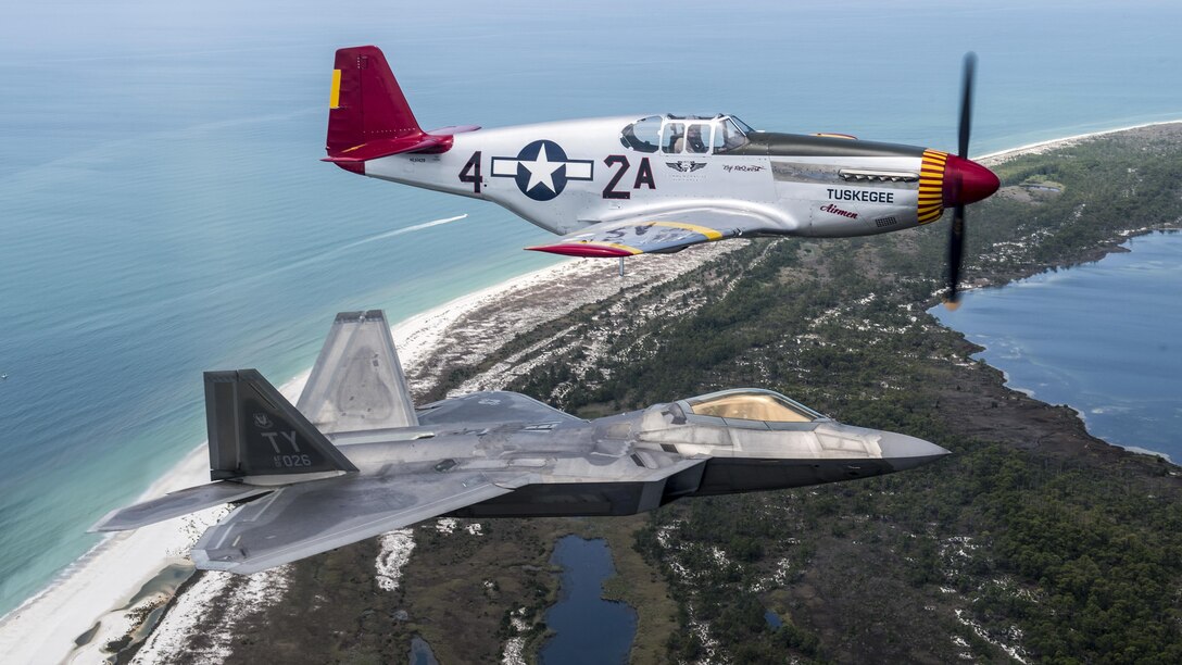 An Air Force F-22 Raptor flies in formation with a World War II-era P-51 Mustang over Panama City Beach, Fla., April 22, 2017, as part of the opening ceremony of the Gulf Coast Salute Air Show. Air Force photo by Staff Sgt. Jason Couillard