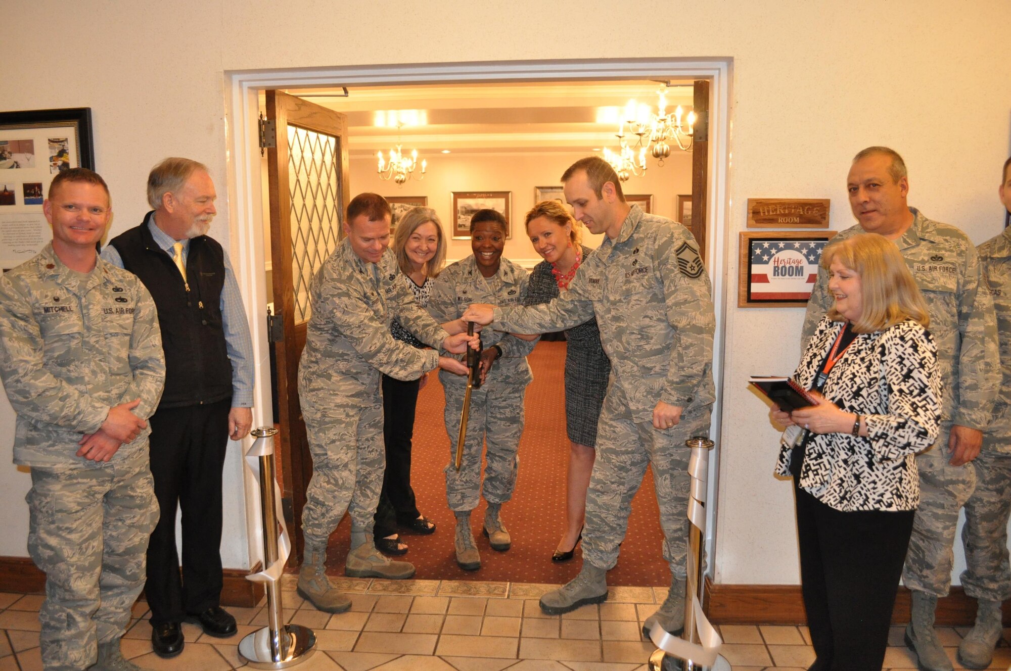 Cutting the ribbon April 6 on the new Tinker Club Heritage Room are, from left, 72nd Mission Support Group Commander Col. Michael Green; Laura Culberson, past president of the Tinker Heritage Foundation; Col. Stephanie Wilson, commander of 72nd Air Base Wing; Marti Ribeiro, Tinker Heritage Foundation secretary; and Senior Master Sgt. James Randol of the 507th Civil Engineer Squadron. 