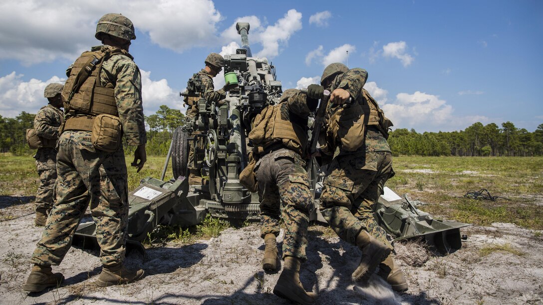Marines load a round into the barrel of an M777 howitzer during a fire mission at Camp Lejeune, N.C., April 20, 2017, as part of a combat readiness evaluation to prepare for an upcoming deployment with the 26th Marine Expeditionary Unit. The Marines are assigned to the 2nd Battalion, 10th Marine Regiment. Marine Corps photo by Pfc. Taylor W. Cooper