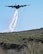 A C130 Hercules aircraft from the 152nd Airlift Wing of Reno, Nevada, loaded with the Modular Airborne Fire Fighting System, drops a water line while training to contain wildfires just outside Boise, Idaho, April 21, 2017. More than 400 personnel from four C-130 Guard and Reserve units — from California, Colorado, Nevada and Wyoming, making up the Air Expeditionary Group — are in Boise for the week-long wildfire training and certification sponsored by the U.S. Forest Service. (U.S. Air National Guard photo/Staff Sgt. Nieko Carzis) 