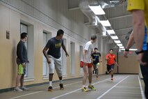 Airmen participate in a relay race at the base fitness center during sports day April 21, 2017, at Malmstrom Air Force Base, Mont. Multiple teams took turns running laps and passing a baton to gain points toward first place and taking home the sports day trophy. (U.S. Air Force photo/Airman 1st Class Daniel Brosam)
