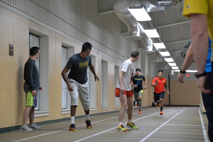 Airmen participate in a relay race at the base fitness center during sports day April 21, 2017, at Malmstrom Air Force Base, Mont. Multiple teams took turns running laps and passing a baton to gain points toward first place and taking home the sports day trophy. (U.S. Air Force photo/Airman 1st Class Daniel Brosam)