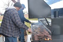 Volunteers grill hamburgers at Sun Plaza Park during sports day April 21, 2017, at Malmstrom Air Force Base, Mont. Airmen took a break from the sports events to partake in hamburgers and refreshments that were served for lunch. (U.S. Air Force photo/Airman 1st Class Daniel Brosam)
