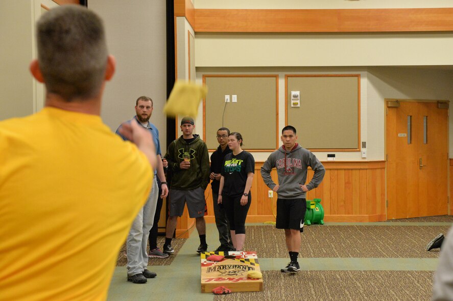 Senior Master Sgt. Daniel Doble, 341st Comptroller Squadron and Wing Staff Agency superintendent, tosses a bag during a game of cornhole April 21, 2017, at Malmstrom Air Force Base, Mont. WSA placed second with a combined 60 points. (U.S. Air Force photo/Airman 1st Class Daniel Brosam)