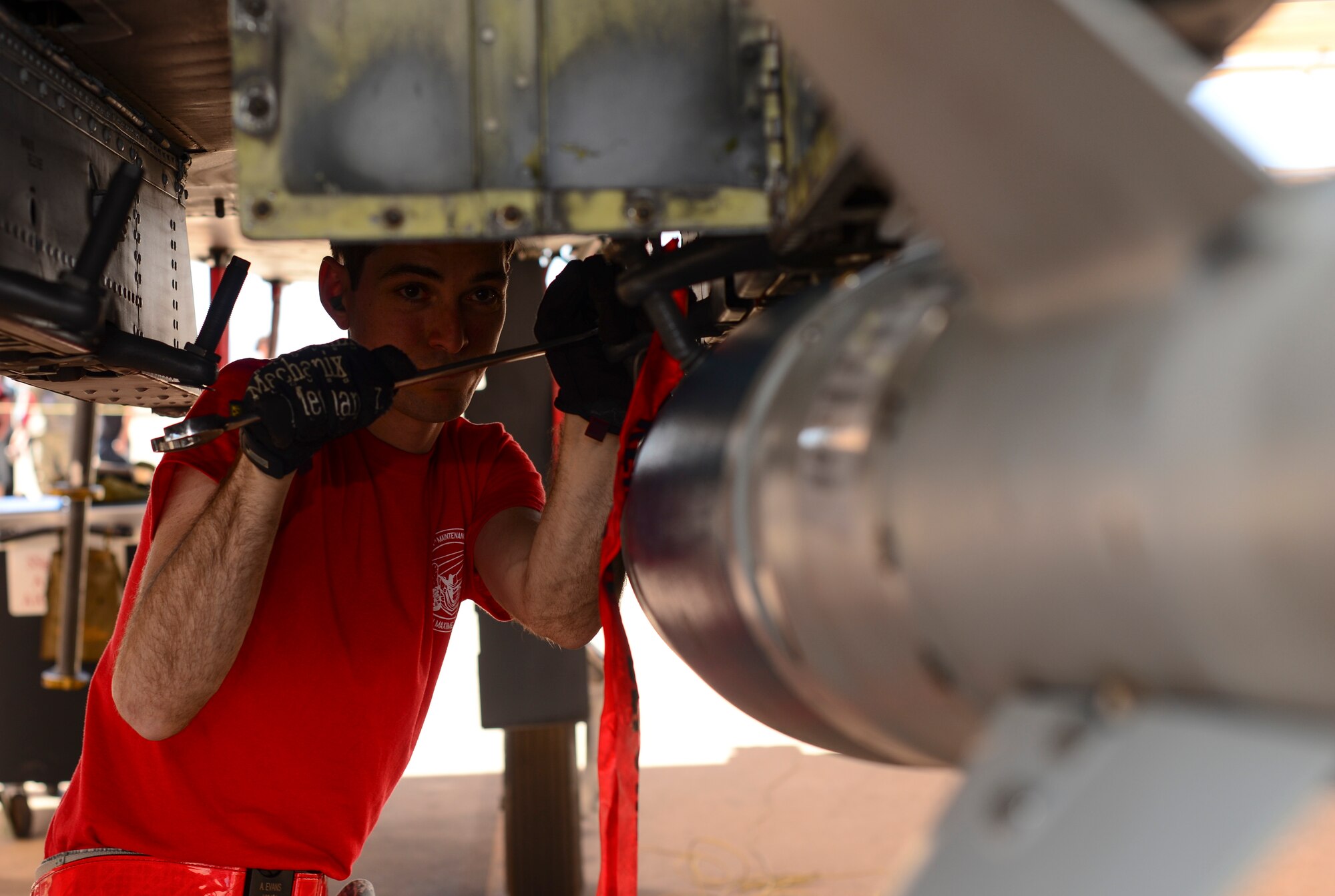 U.S. Air Force Airman 1st Class Alexander Evans, 924th Aircraft Maintenance Unit load crew team member, secures a Guided Bomb Unit-38 onto an A-10C Thunderbolt II during a load crew of the quarter competition at Davis-Monthan Air Force Base, Ariz., April 21, 2017. Three teams competed against each other to determine which one could load munitions onto an A-10 with minimal errors in the least amount of time possible. (U.S. Air Force photo by Airman 1st Class Nathan H. Barbour)