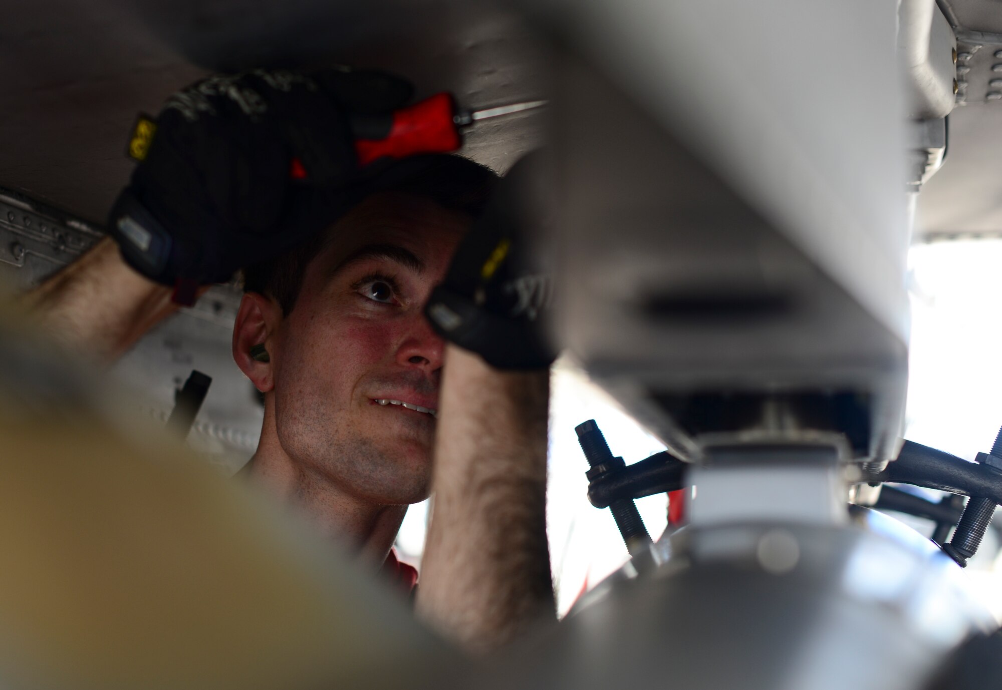 U.S. Air Force Airman 1st Class Alexander Evans, 924th Aircraft Maintenance Unit load crew team member, secures a Guided Bomb Unit-38 onto an A-10C Thunderbolt II during a load crew of the quarter competition at Davis-Monthan Air Force Base, Ariz., April 21, 2017. Three teams from the 354th, 357th and 924th aircraft maintenance units competed against each other to determine which one could load munitions onto an A-10 with minimal errors in the least amount of time possible.  (U.S. Air Force photo by Airman 1st Class Nathan H. Barbour)