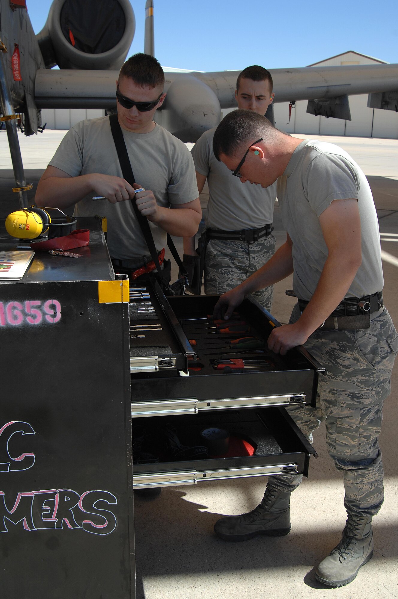 U.S. Air Force Staff Sgt. Christopher Ouellet, Airman 1st Class Erik Wiley and Zachary Rhodes, 357th Aircraft Maintenance Unit load crew team members, check tool accountability before a load crew of the quarter competition at Davis-Monthan Air Force Base, Ariz., April 21, 2017. Airmen from each load crew team were handpicked by their leadership to participate in the competition. (U.S. Air Force photo by Airman 1st Class Frankie D. Moore)