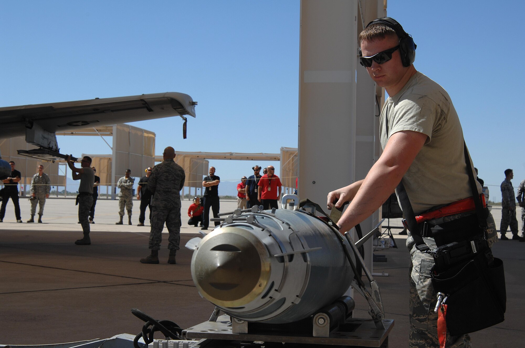 U.S. Air Force Staff Sgt. Christopher Ouellet, 357th Aircraft Maintenance Unit weapons load crew team member, secures a Guided Bomb Unit-38 to be loaded onto an A-10C Thunderbolt II during a load crew of the quarter competition at Davis-Monthan Air Force Base, Ariz., April 21, 2017. The quarterly events allow Airmen to exhibit their teamwork on a competitive platform, while providing conditions to spark the sense of urgency and attention to detail that are imperative for Airmen to destroy enemies downrange. (U.S. Air Force photo by Airman 1st Class Frankie D. Moore)