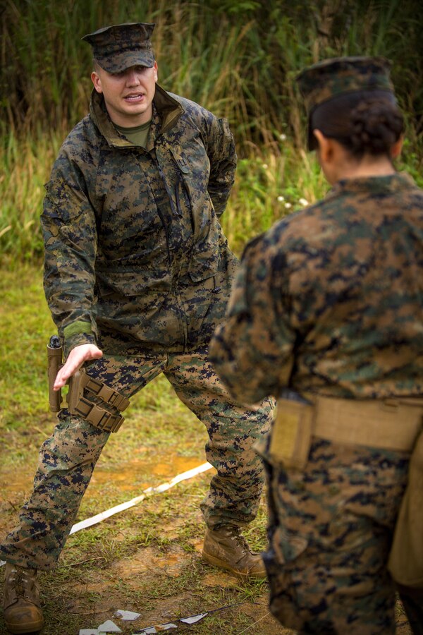 Capt. Troy D. Goss provides feedback to 2nd Lt. Jennifer N. Galvan during a Marine Corps Combat Readiness Evaluation at Central Training Area, Camp Hansen, April 18, 2017. 3d Law Enforcement Battalion conducted the evaluation to test each company’s ability to execute tasks ranging from policing operations to police patrolling, route regulations, key leader engagements in towns and local population centers, and security of key infrastructure in an expeditionary environment, to ensure they are prepared to support the operational requirements of III Marine Expeditionary Force. Goss, a native of Jacksonville, N.C., is the commanding officer of Bravo Company, 3d LE Bn., III MEF Headquarters Group. Galvan, a native of Oak Lawn, Ill., is a platoon commander for Bravo Company, 3d LE Bn., III MEF Headquarters Group. (U.S. Marine Corps photo by Lance Cpl. Joshua Pinkney)