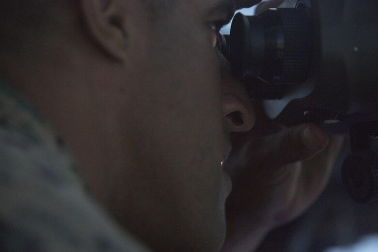 Cpl. William Alexander, an anti-tank missleman assigned to 1st Battalion, 3rd Marine Regiment, looks through a vector defense advanced GPS receiver during Joint Fires Observer Course aboard Marine Corps Base Hawaii on March 29, 2017. The JFO course prepares Marines for deployments by teaching them to coordinate, observe and utilize close air support. (U.S. Marine Corps photo by Lance Cpl. Matthew Kirk)
