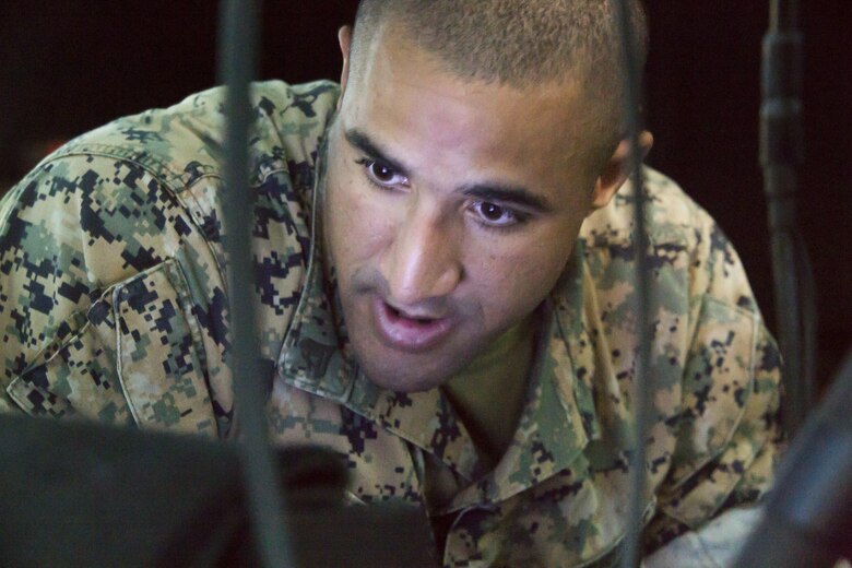 Cpl. William Alexander, an anti-tank missleman assigned to 1st Battalion, 3rd Marine Regiment, studies his coordinates during Joint Fires Observers Course aboard Marine Corps Base Hawaii on March 29, 2017. The JFO course prepares Marines for deployments by teaching them to coordinate, observe and utilize close air support. (U.S. Marine Corps photo by Lance Cpl. Matthew Kirk)