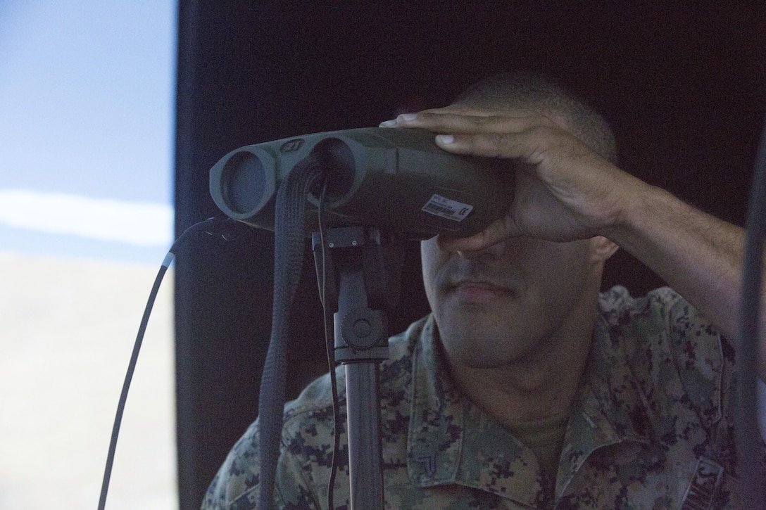 Cpl. William Alexander, an anti-tank missleman assigned to 1st Battalion, 3rd Marine Regiment, looks through a vector defense advanced GPS receiver during Joint Fires Observer Course aboard Marine Corps Base Hawaii on March 29, 2017. The JFO course prepares Marines for deployments by teaching them to coordinate, observe and utilize close air support. (U.S. Marine Corps photo by Lance Cpl. Matthew Kirk)