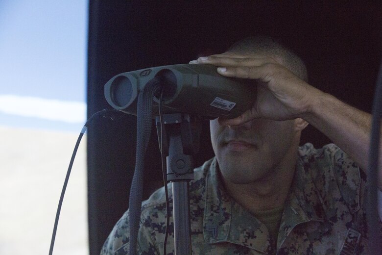 Cpl. William Alexander, an anti-tank missleman assigned to 1st Battalion, 3rd Marine Regiment, looks through a vector defense advanced GPS receiver during Joint Fires Observer Course aboard Marine Corps Base Hawaii on March 29, 2017. The JFO course prepares Marines for deployments by teaching them to coordinate, observe and utilize close air support. (U.S. Marine Corps photo by Lance Cpl. Matthew Kirk)