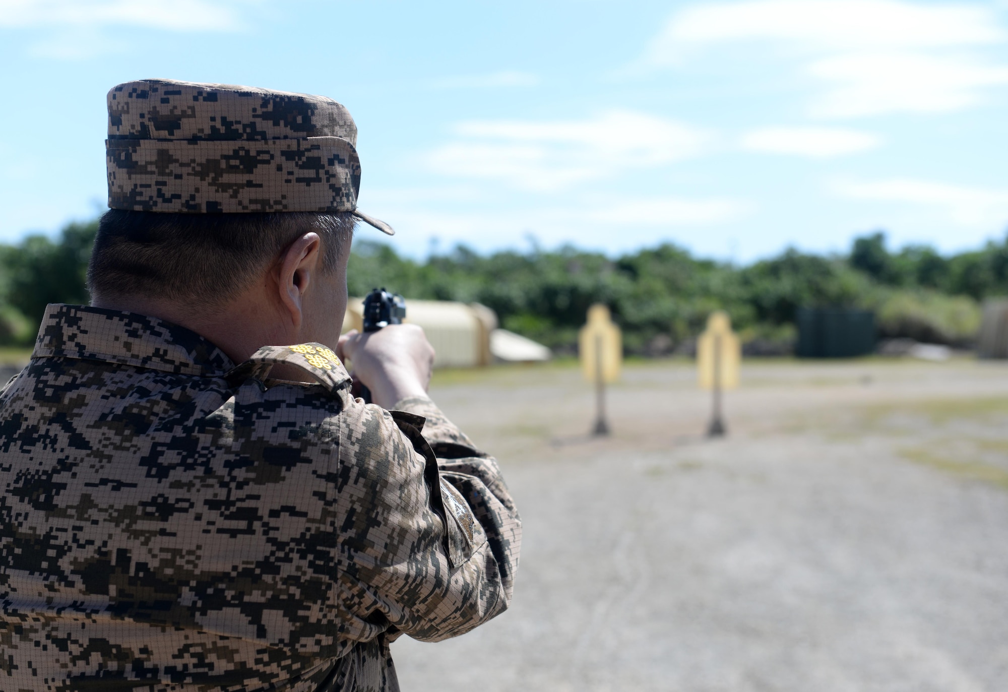 A Mongolian Air Force service member aims a M9 Beretta during the firing portion of Pacific Defender 17-1, April 11, 2017, at Andersen Air Force Base, Guam. Pacific Defender, is designed to establish integrated defensive cooperation with Indo-Asia-Pacific nations, while promoting regional stability and military relations. (U.S Air Force photo by Airman 1st Class Gerald R. Willis/Released)