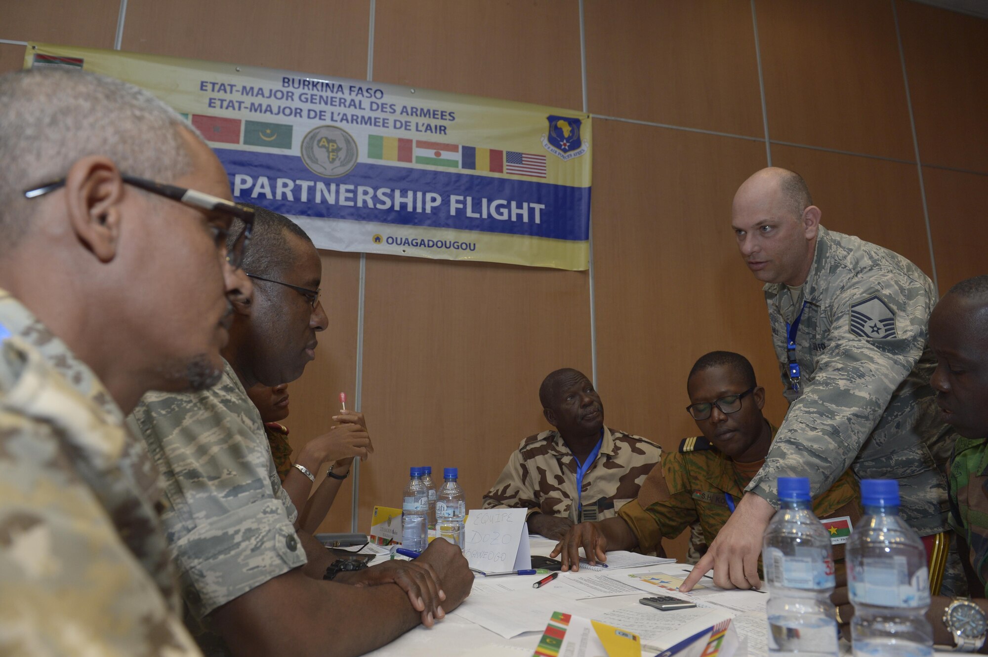 U.S. Air Force Master Sgt. Johnny Hall, right, 818th Mobility Support Advisory Squadron air advisor aircraft maintenance, talks with African Partnership Flight participants during a table top workshop in Ouagadougou, Burkina Faso, April 20, 2017. The intent of APF is to build strong transparent partnerships that enhance regional stability and security through formal alliances, partnerships and simple exchanges of information. (U.S. Air Force photo by Staff Sgt. Jonathan Snyder)