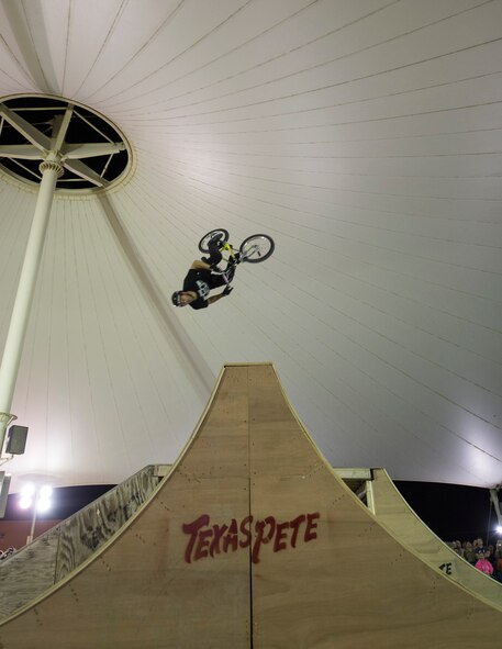 A Bikes Over Baghdad BMX rider jumps over a ramp at Al Udeid Air Base, Qatar, April 20, 2017. Bikes Over Baghdad is a professional team of BMX Riders who travel throughout the U.S. Central Command area of responsibility putting on shows for service members. (U.S. Air Force photo by Tech. Sgt. Amy M. Lovgren)